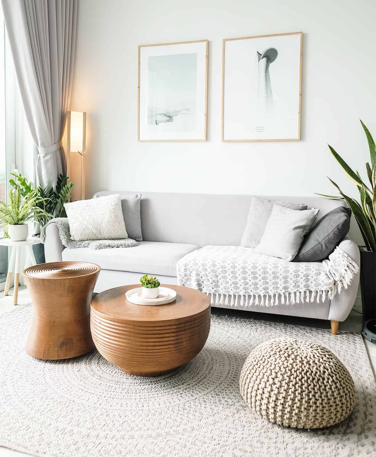 A calm, neutral living room with warm timber furniture.